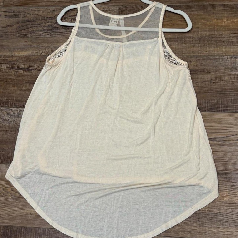Cream lace tank top with sheer mesh and lace trim on the shoulders